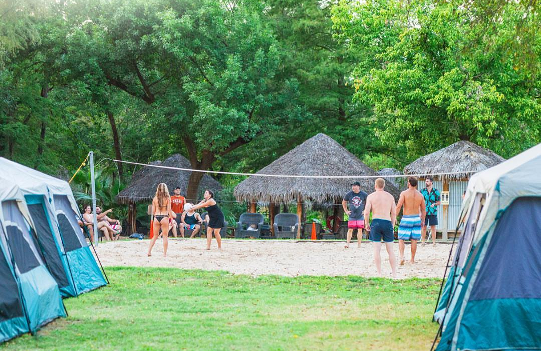 Beach volleyball game with cabanas