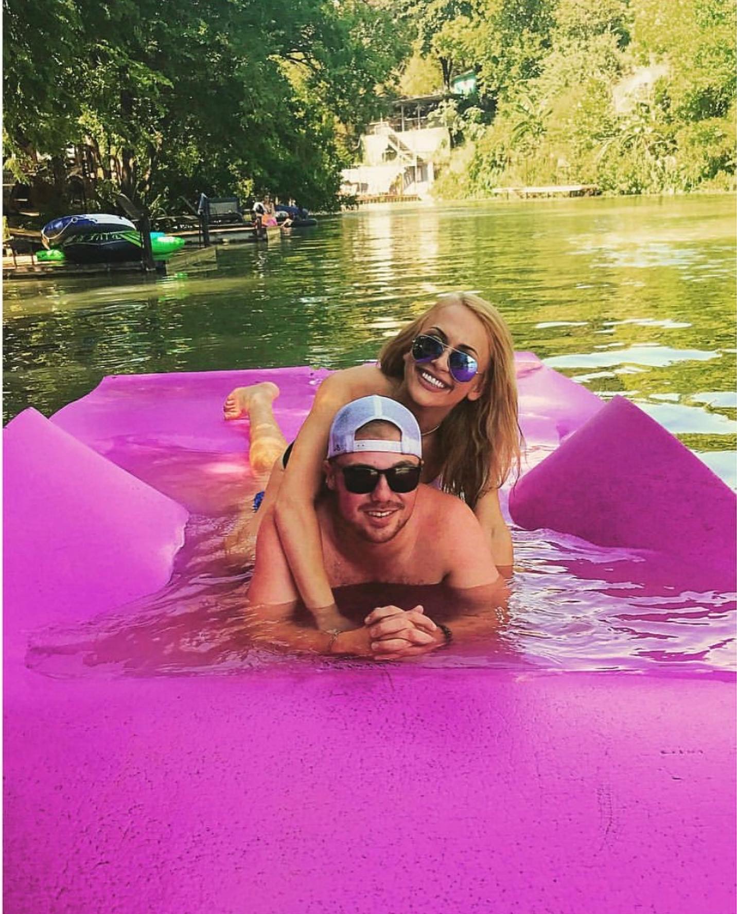 Couple relaxing on floating mat